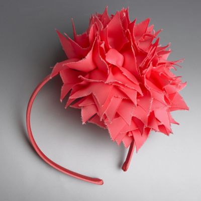Coral ribbon rosette fascinator