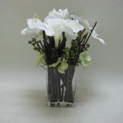 White Amaryllis and berries in small glass vase